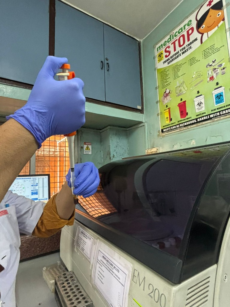 Medicare NABL-accredited pathology laboratory — technician at diagnostic analyzer